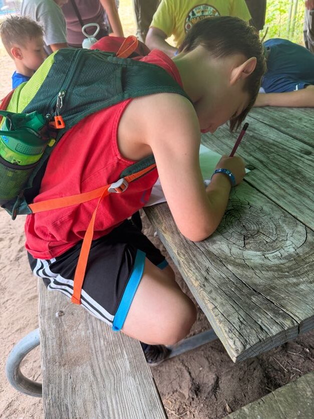 Scout working on an activity at a picnic table