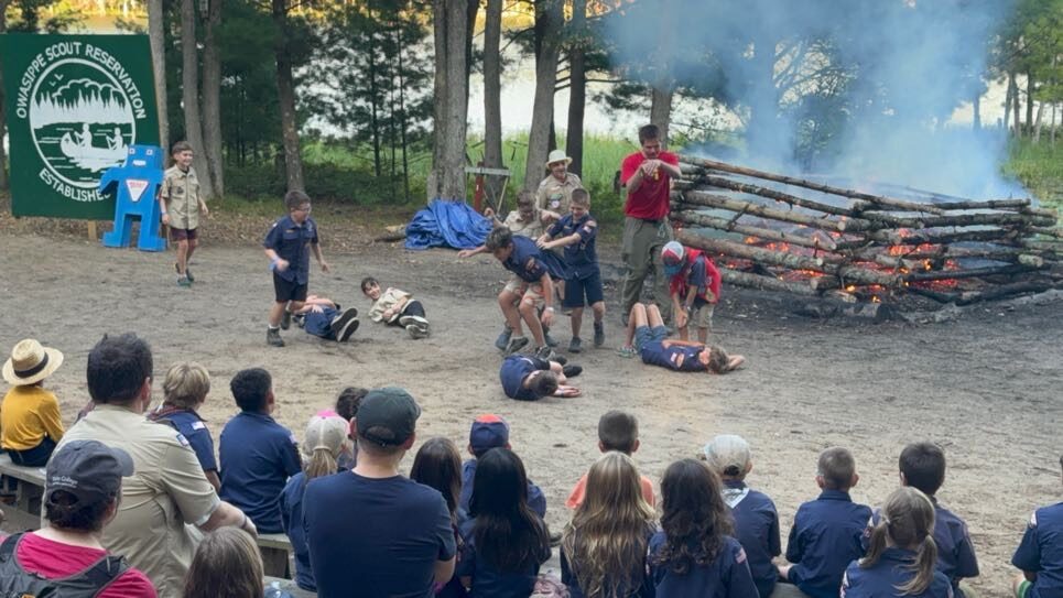 Scouts and families gathered at a lakeside campsite